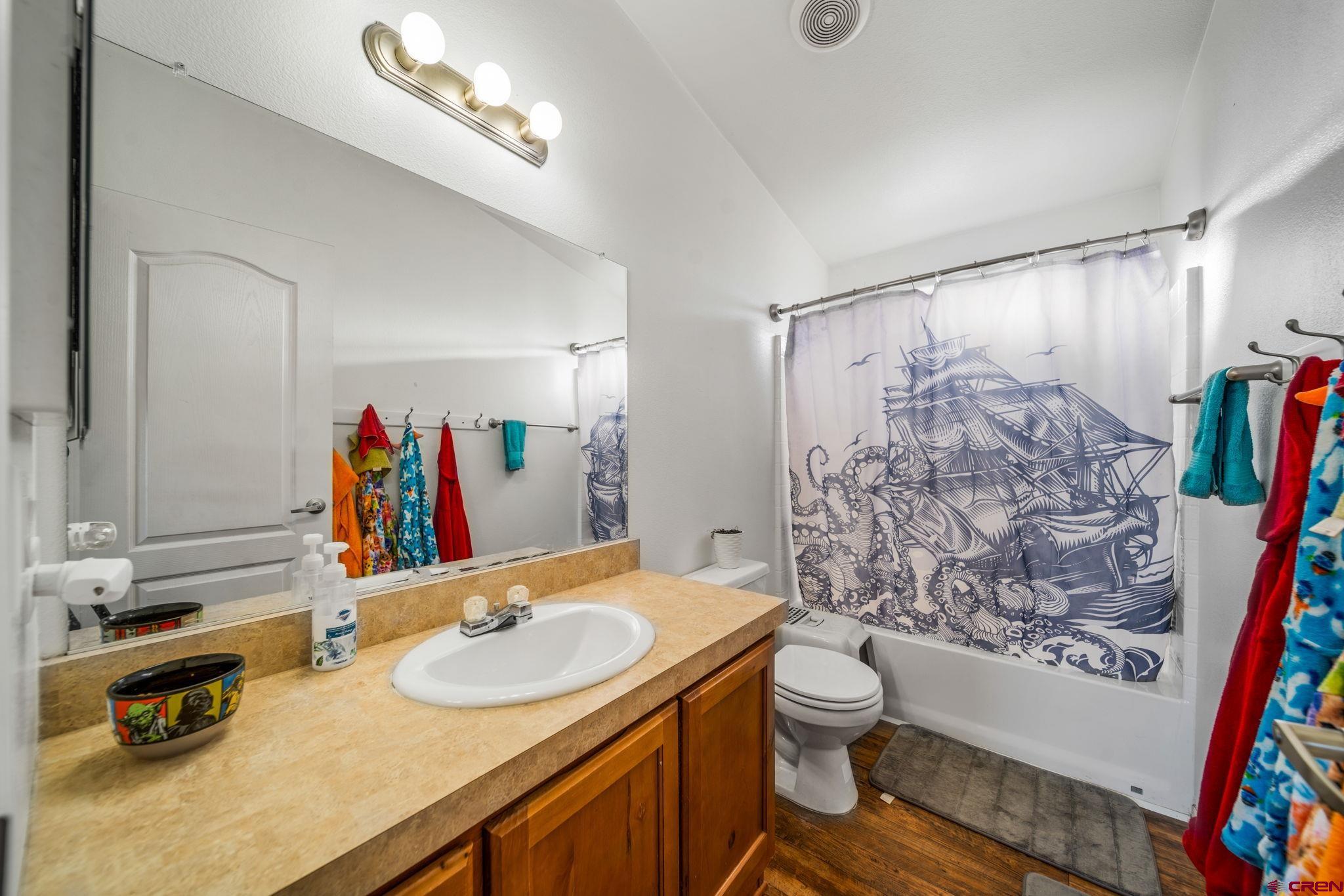 75 Sundial Lane Ignacio, CO 81137 - Photo 18 of 31 a bathroom with a sink a toilet and shower curtain
