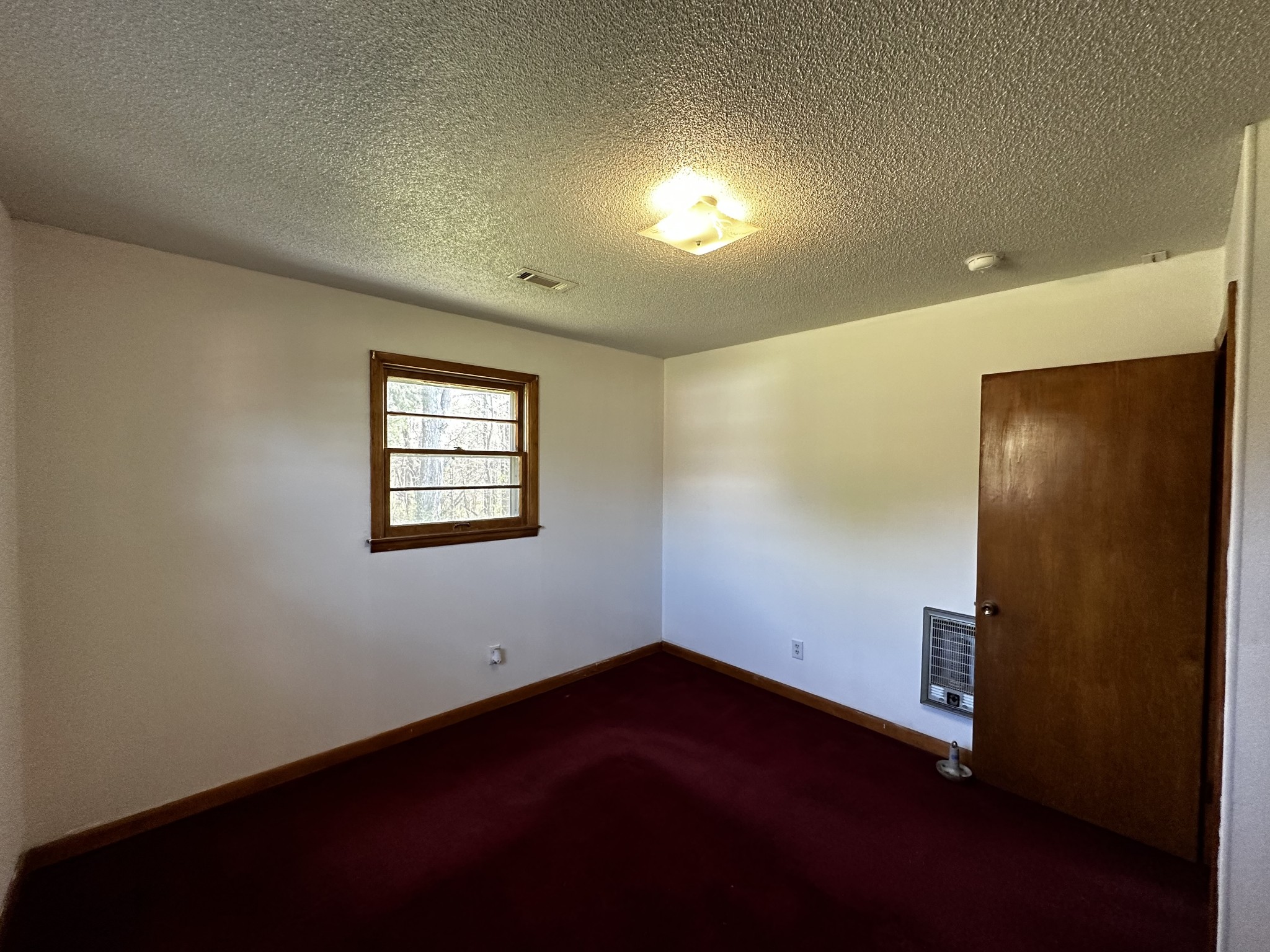 71 Hillcrest Villa Road Manchester, TN 37355 - Photo 23 of 47 an empty room with wooden floor and windows