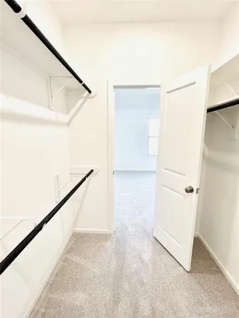 a view of a hallway with white walls and stairs