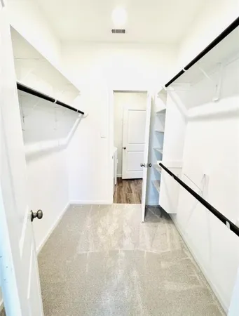 a view of a big room with closet and windows