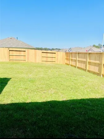 a view of an ocean with a floor to ceiling windows and yard