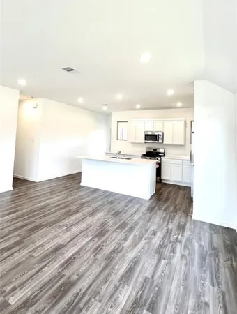 a view of kitchen with wooden floor
