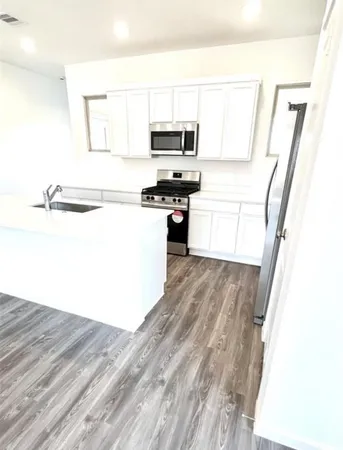a kitchen with a refrigerator and a stove