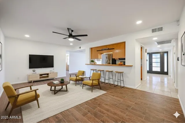 a living room with furniture and a flat screen tv