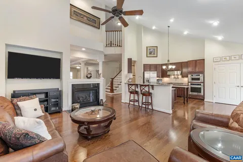 a living room with furniture a rug and a large window