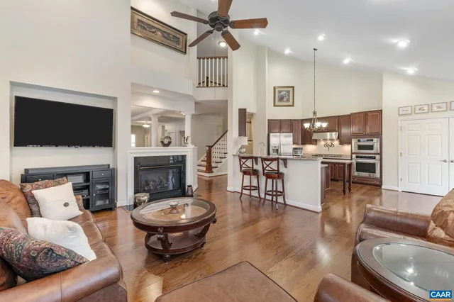 a living room with furniture a rug and a large window