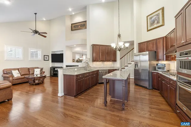 a kitchen with granite countertop stainless steel appliances and wooden cabinets