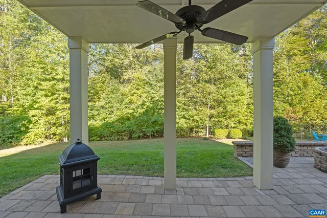 a view of a house with backyard sitting area and garden