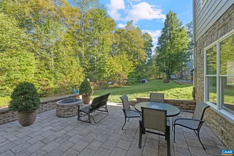 a large kitchen with stainless steel appliances kitchen island granite countertop a large counter top a sink a stove and a refrigerator