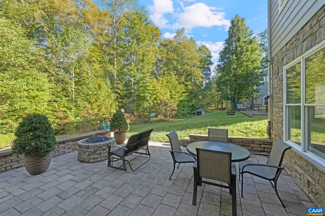 a large kitchen with stainless steel appliances kitchen island granite countertop a large counter top a sink a stove and a refrigerator