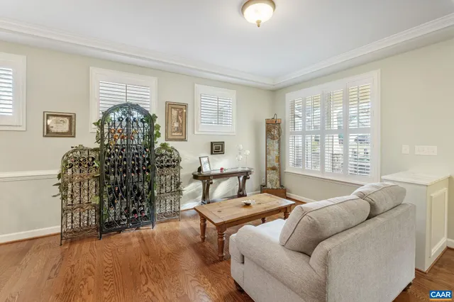a dining room with furniture a chandelier and wooden floor