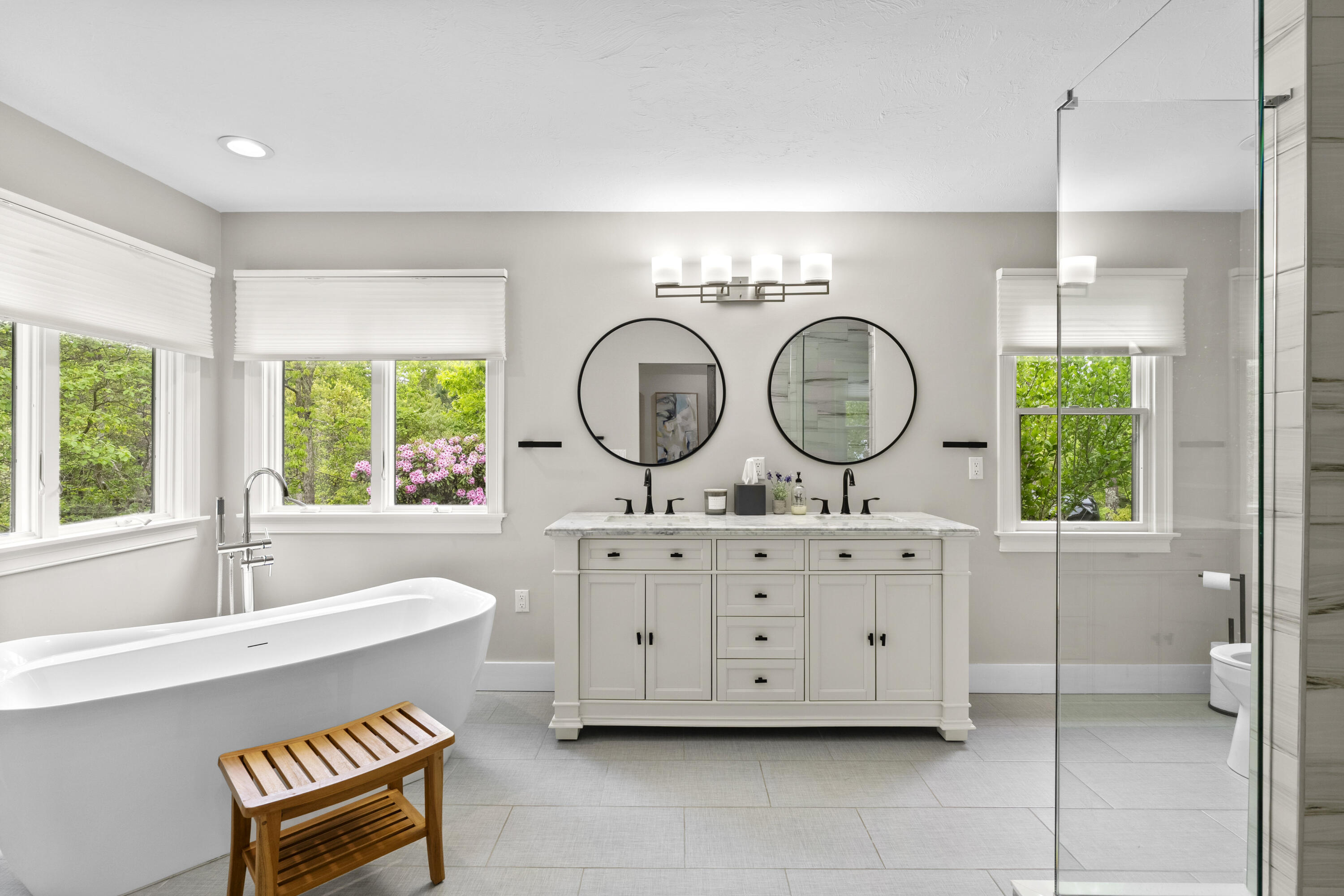 102 Cairn Ridge Road East Falmouth, MA 02536 - Photo 21 of 56 a bathroom with a granite countertop bathtub a sink and a large mirror