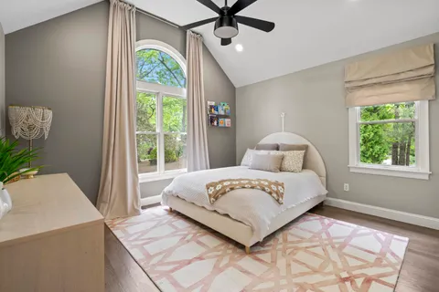 a bedroom with a bed and a chandelier