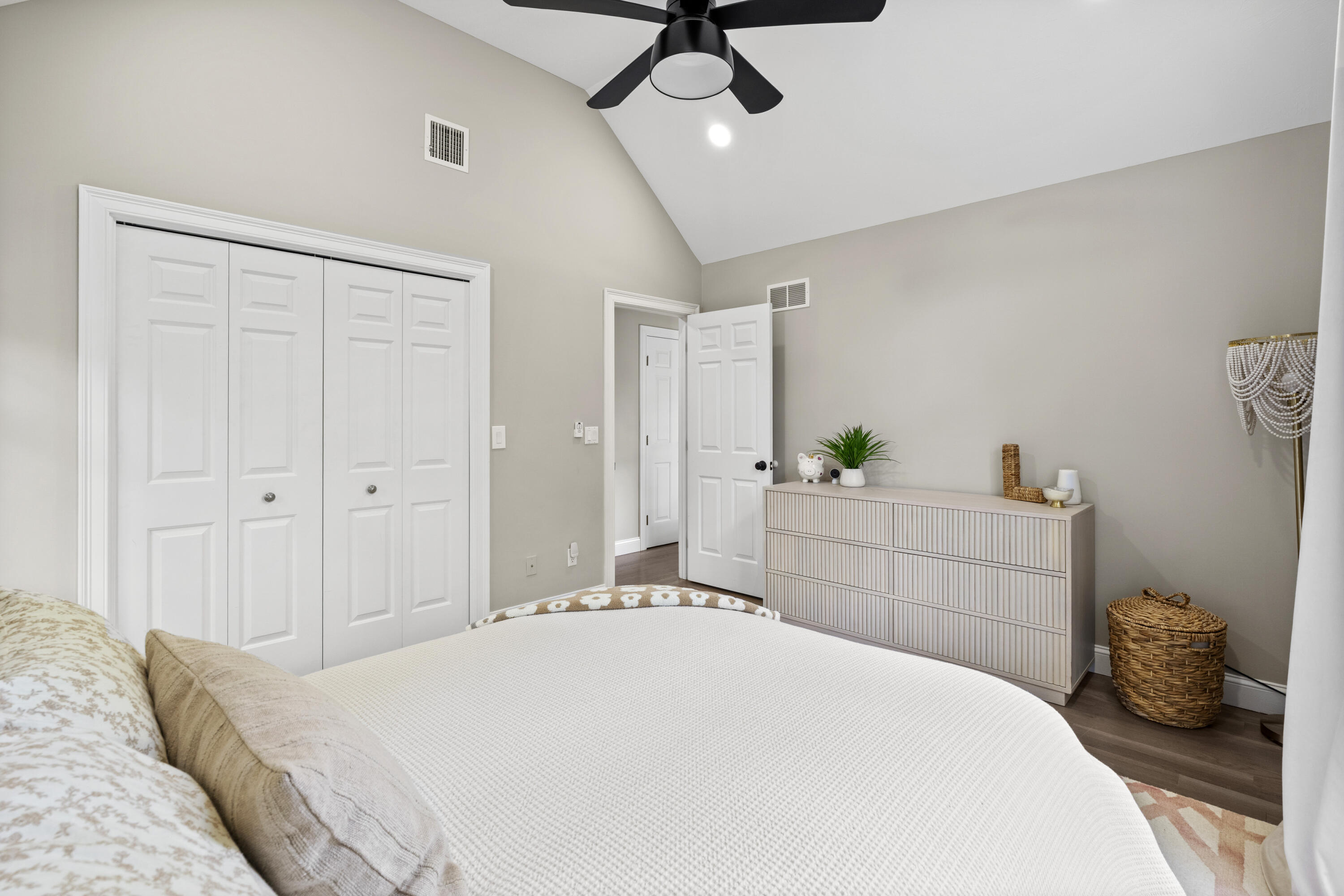 102 Cairn Ridge Road East Falmouth, MA 02536 - Photo 27 of 56 a bedroom with a bed and a chandelier