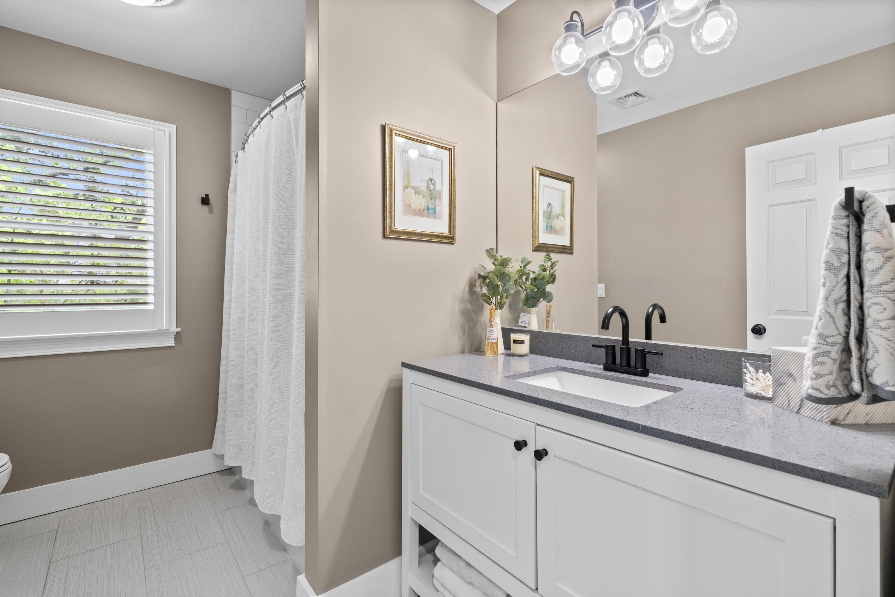 102 Cairn Ridge Road East Falmouth, MA 02536 - Photo 29 of 56 a bathroom with a granite countertop sink a large mirror and a window