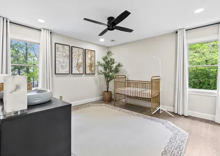 a bedroom with a bed and a dresser with the mirror
