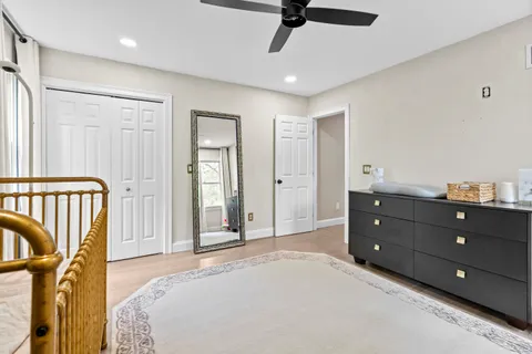 a living room with furniture and view of kitchen