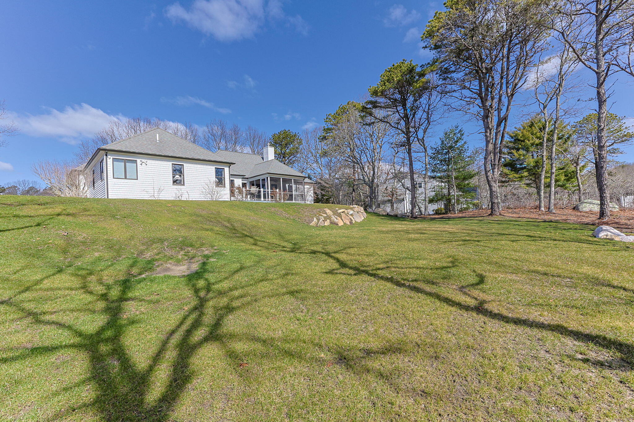 102 Cairn Ridge Road East Falmouth, MA 02536 - Photo 46 of 56 a view of a big house with a big yard and large trees