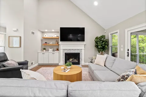 a living room with furniture and a fireplace