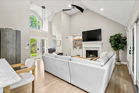 a living room with furniture a fireplace and a flat screen tv