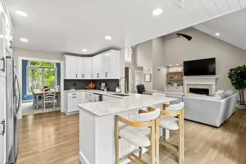 a large kitchen with a table and chairs