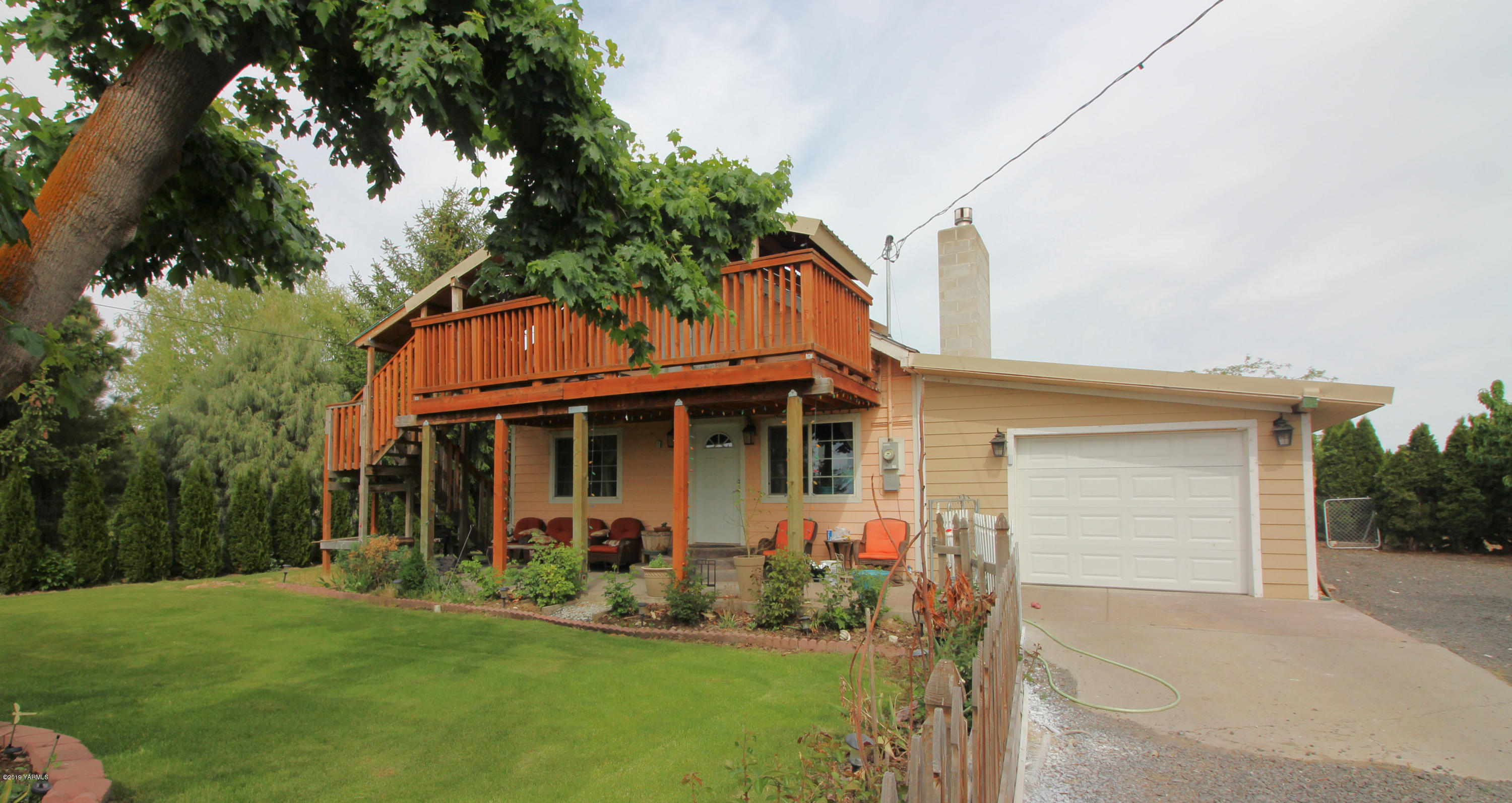 1615 Beaudry Road Yakima, WA 98901 - Photo 1 of 23 a front view of a house with a garden and plants