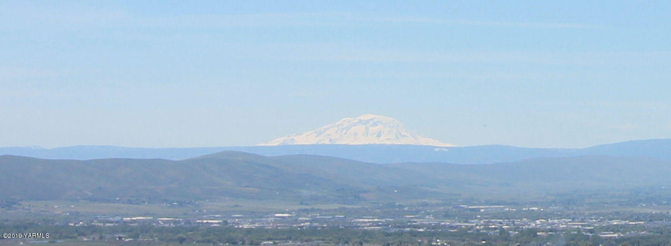 1615 Beaudry Road Yakima, WA 98901 - Photo 22 of 23 a view of a dry field with mountains in the background