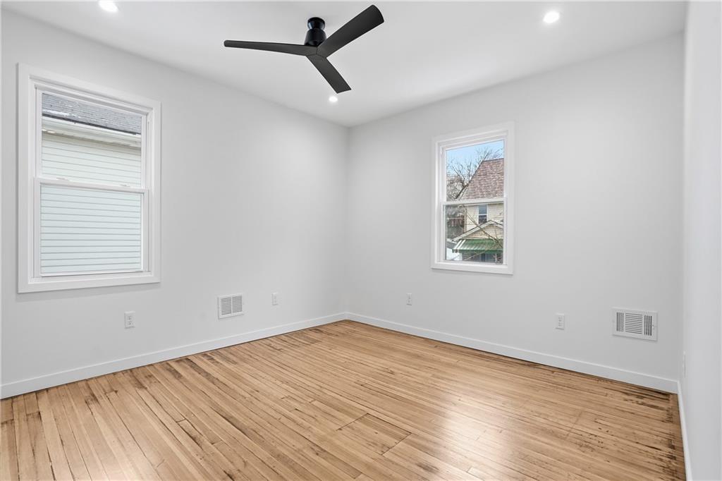 1402 Dickson Street Pittsburgh, PA 15212 - Photo 19 of 25 a view of empty room with wooden floor and fan