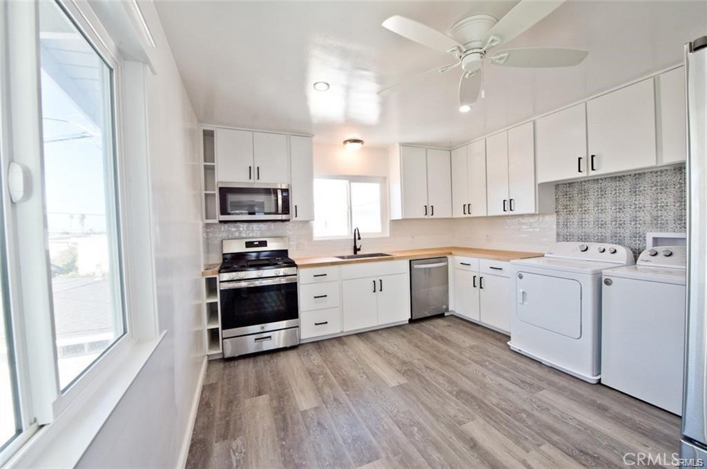 817 Calle Puente, Unit A San Clemente, CA 92672 - Photo 4 of 8 a kitchen with a white cabinets and wooden floor