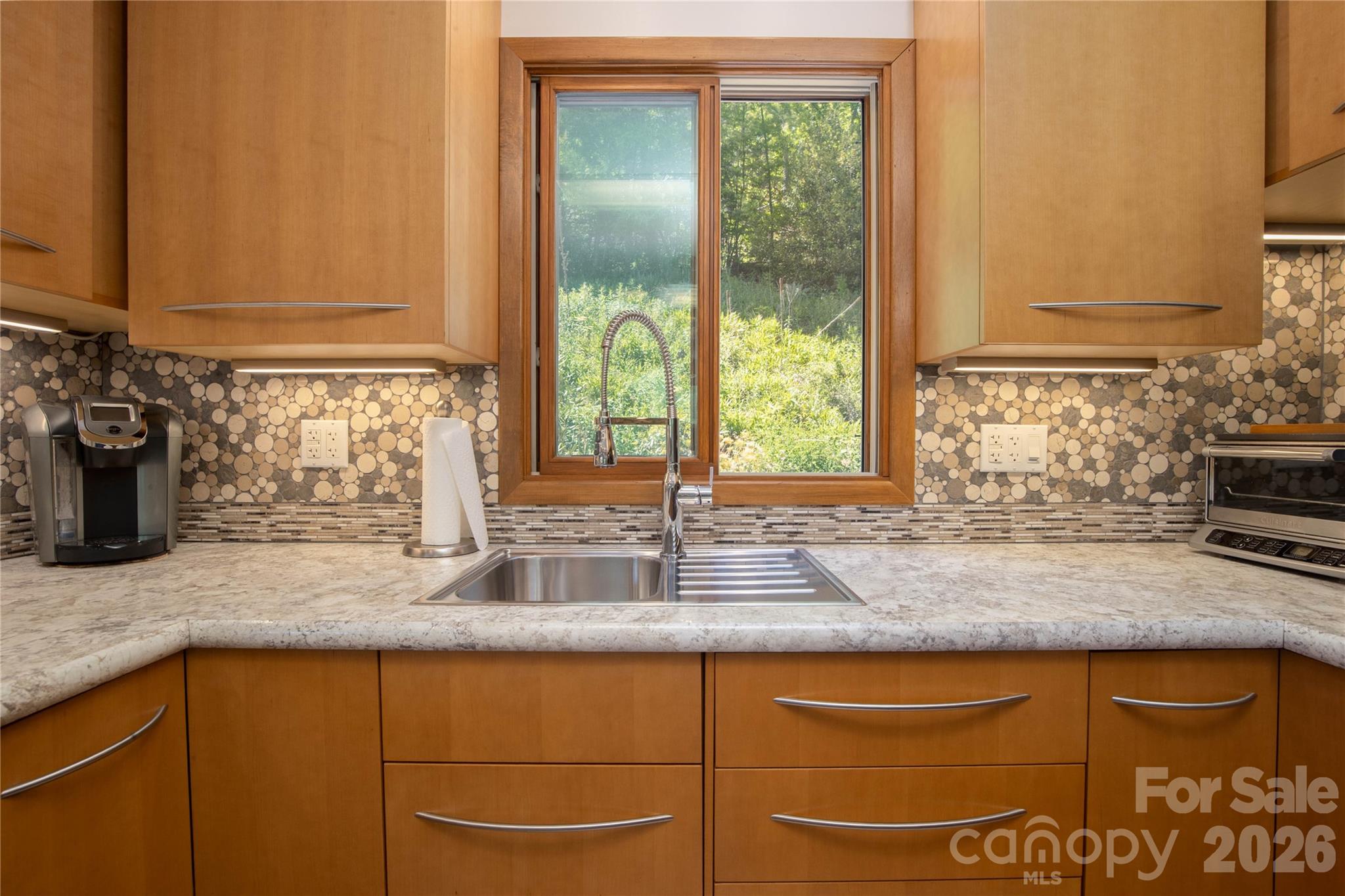 93 Franklin Crest Road Spruce Pine, NC 28777 - Photo 30 of 47 a kitchen with granite countertop a sink and a window