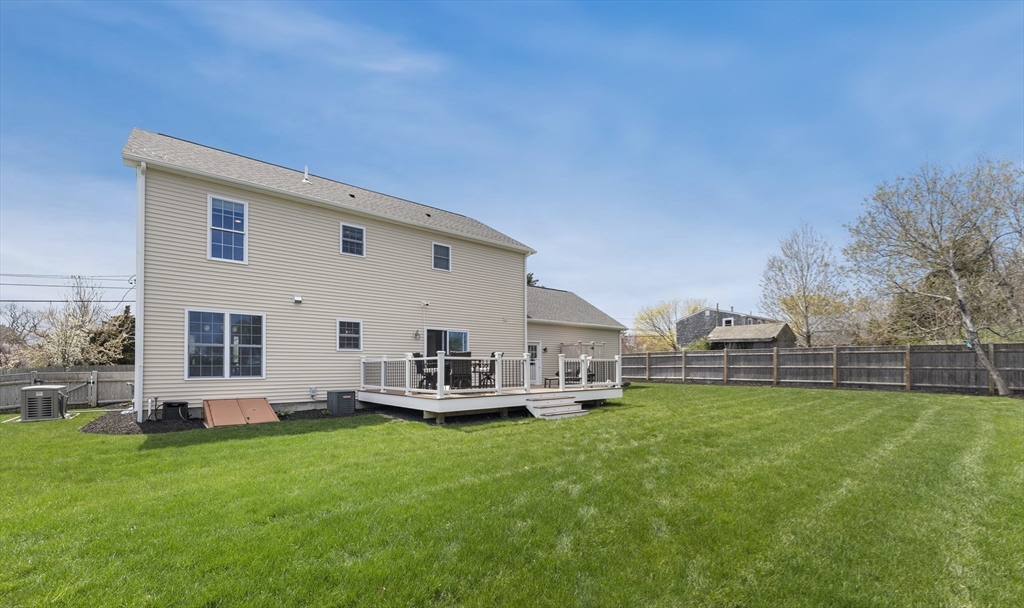 106 Colonial Road Marshfield, MA 02050 - Photo 16 of 16 a view of a house with a yard and sitting area
