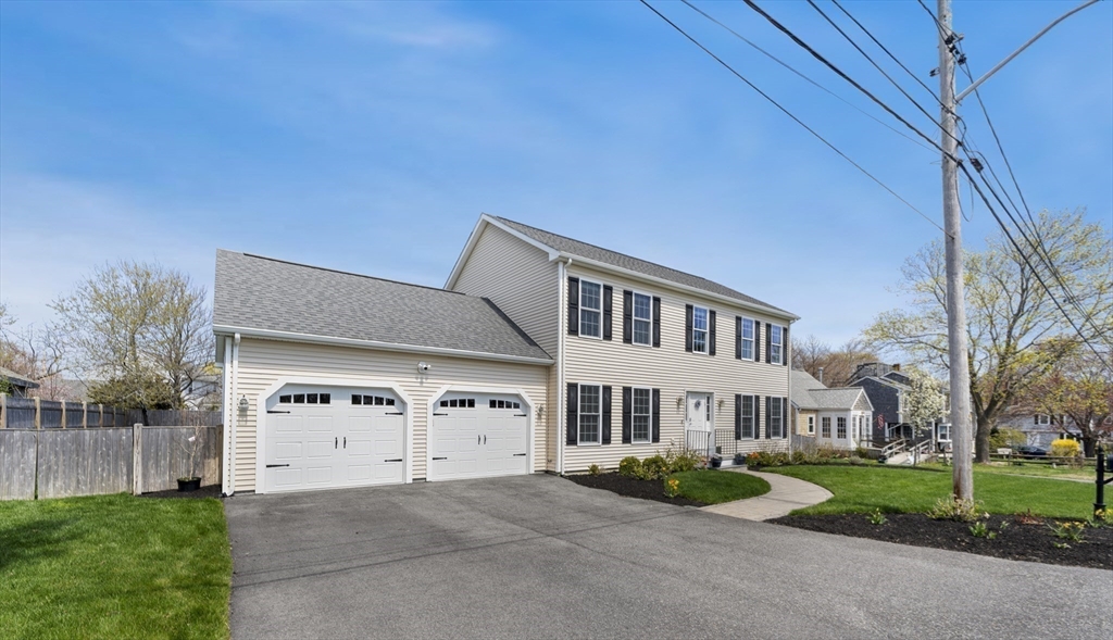 106 Colonial Road Marshfield, MA 02050 - Photo 2 of 16 a front view of a house with garden