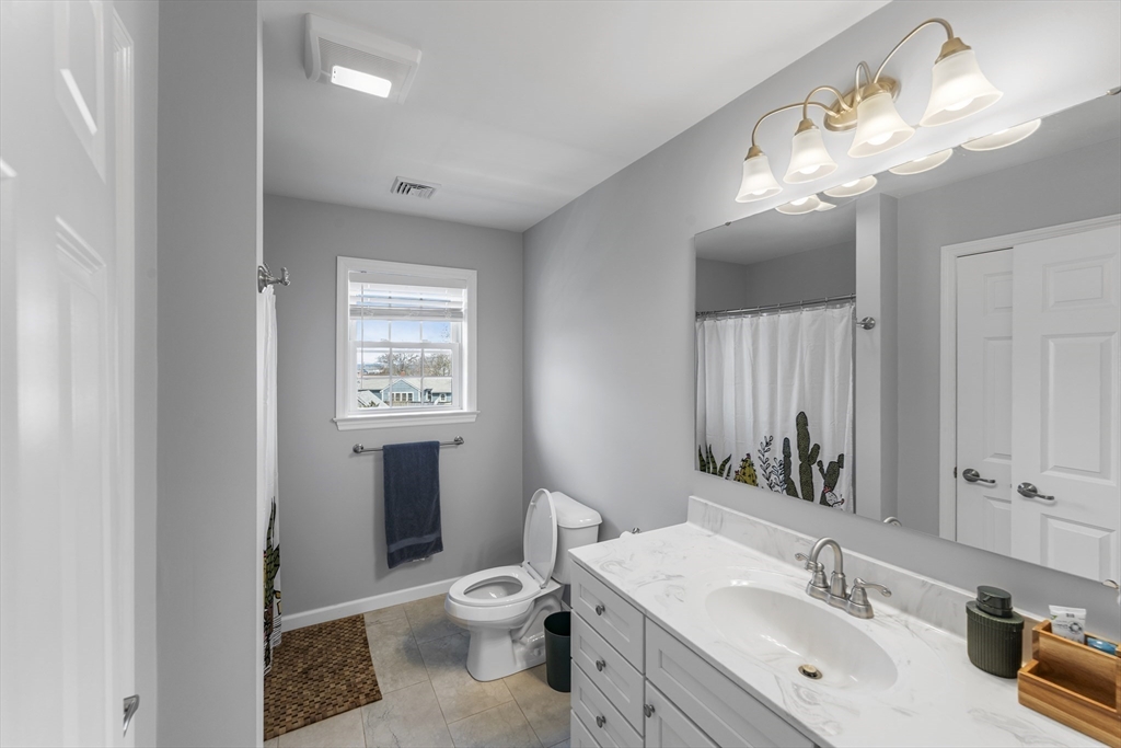 106 Colonial Road Marshfield, MA 02050 - Photo 10 of 16 a bathroom with a sink a toilet and a mirror