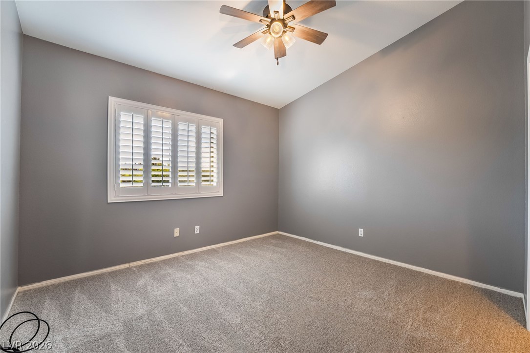 261 Timber Hollow Street Henderson, NV 89012 - Photo 40 of 51 A window with plantation shutters illuminates this comfortably carpeted room, perfect for rest or quiet contemplation.