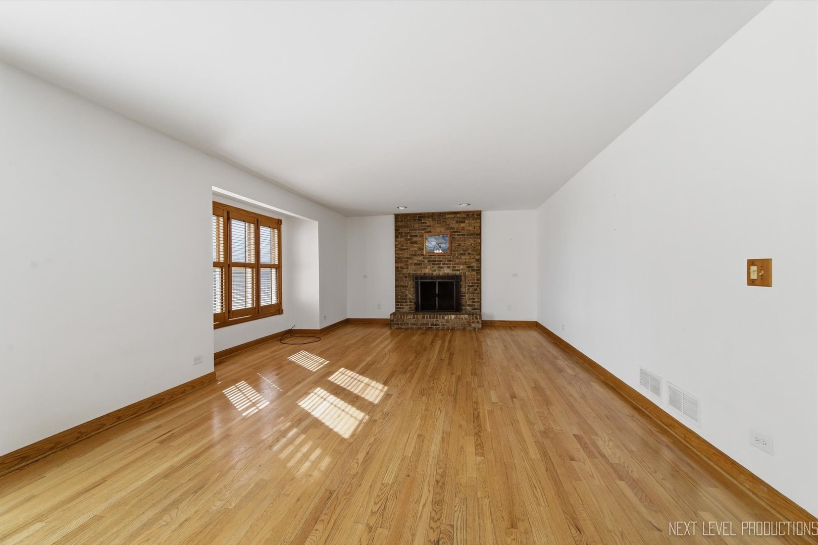 2N879 Howard Road Maple Park, IL 60151 - Photo 13 of 54 a view of empty room with a fireplace and wooden floor