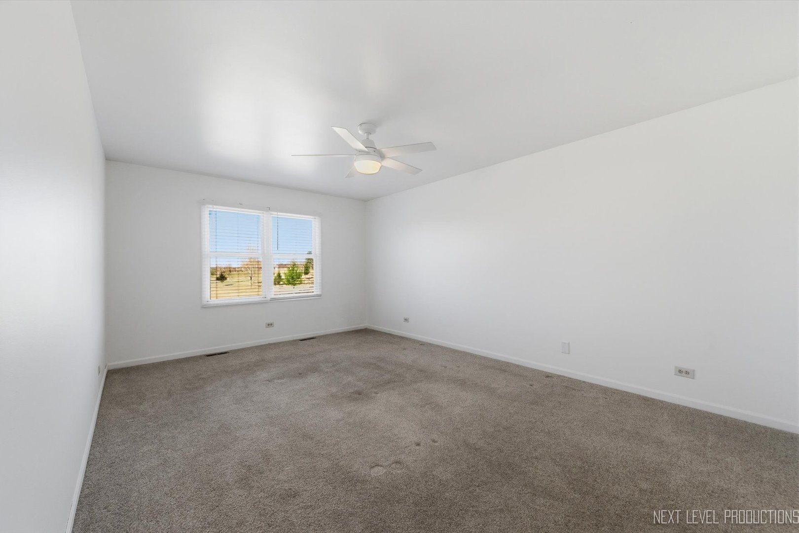 2N879 Howard Road Maple Park, IL 60151 - Photo 18 of 54 an empty room with windows and ceiling fan