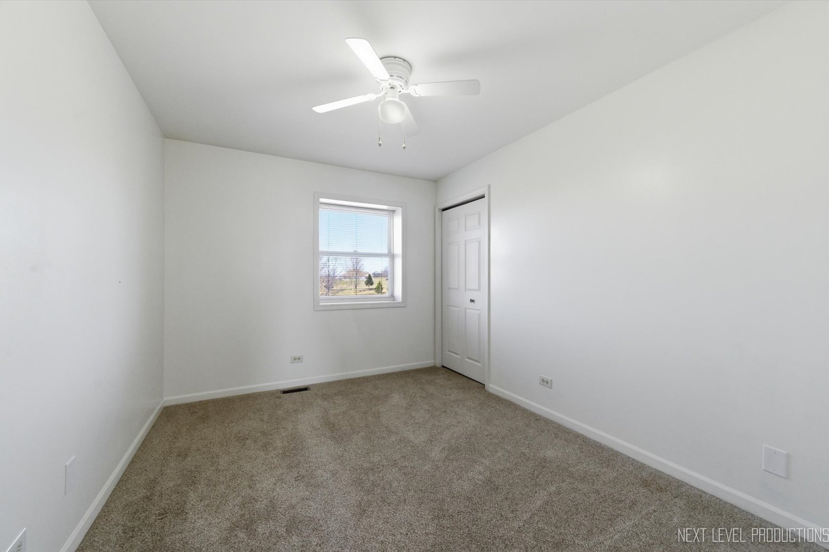 2N879 Howard Road Maple Park, IL 60151 - Photo 23 of 54 an empty room with a chandelier fan and windows