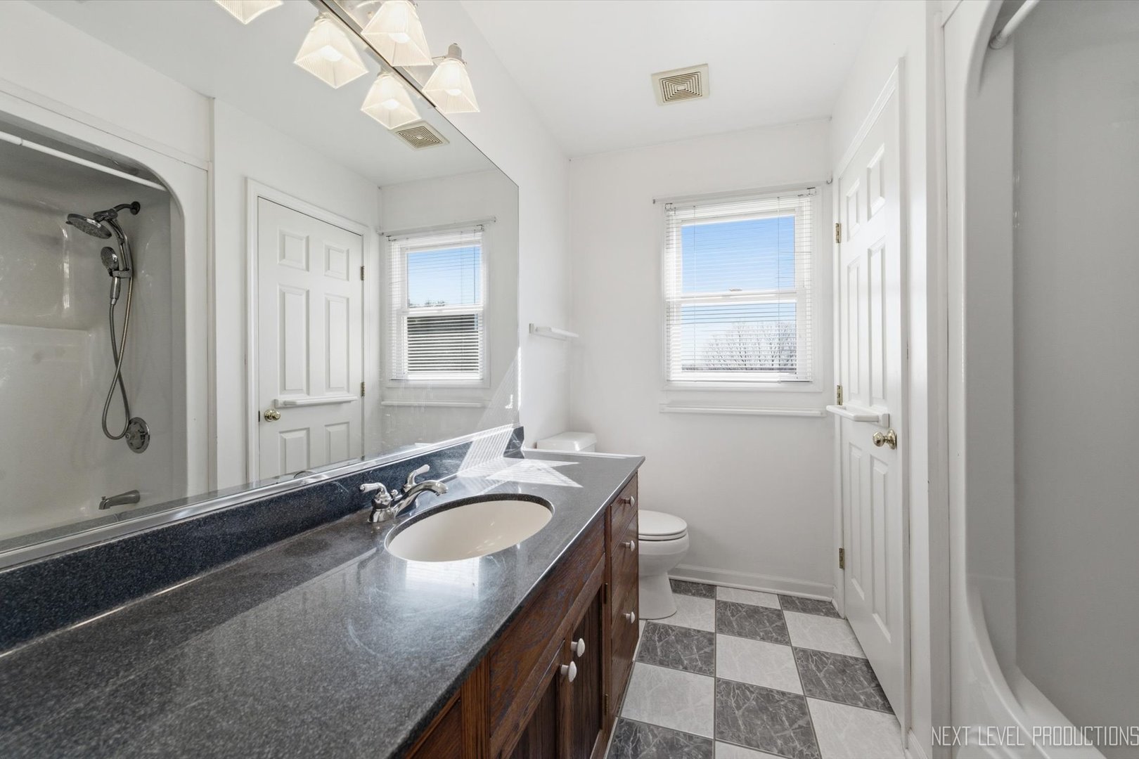 2N879 Howard Road Maple Park, IL 60151 - Photo 26 of 54 a bathroom with a granite countertop sink a mirror a vanity and a shower