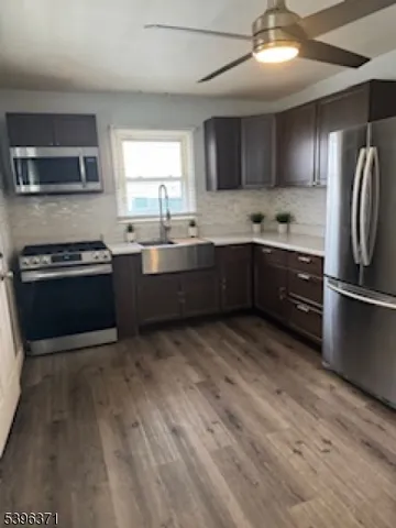 a kitchen with stainless steel appliances granite countertop a sink and stove top oven