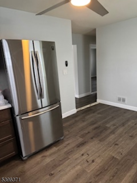 12 Pasadena Avenue Lodi, NJ 07644 - Photo 3 of 10 a view of a refrigerator in kitchen and wooden floor
