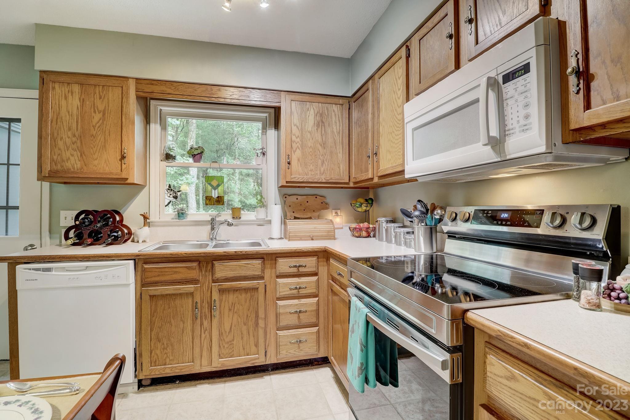 4 Bramblewood Road, Unit 8 Arden, NC 28704 - Photo 11 of 25 a kitchen with a sink stove and cabinets