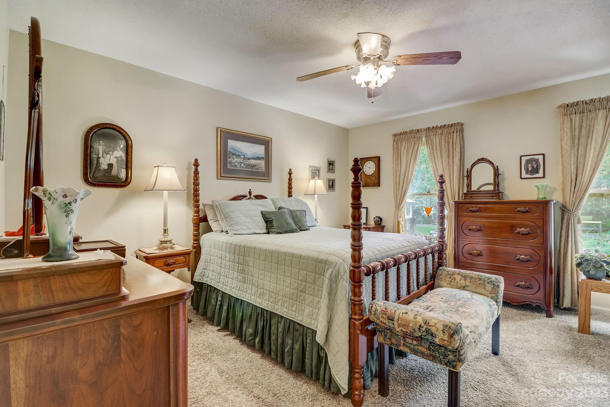4 Bramblewood Road, Unit 8 Arden, NC 28704 - Photo 13 of 25 a bedroom with furniture and a chandelier