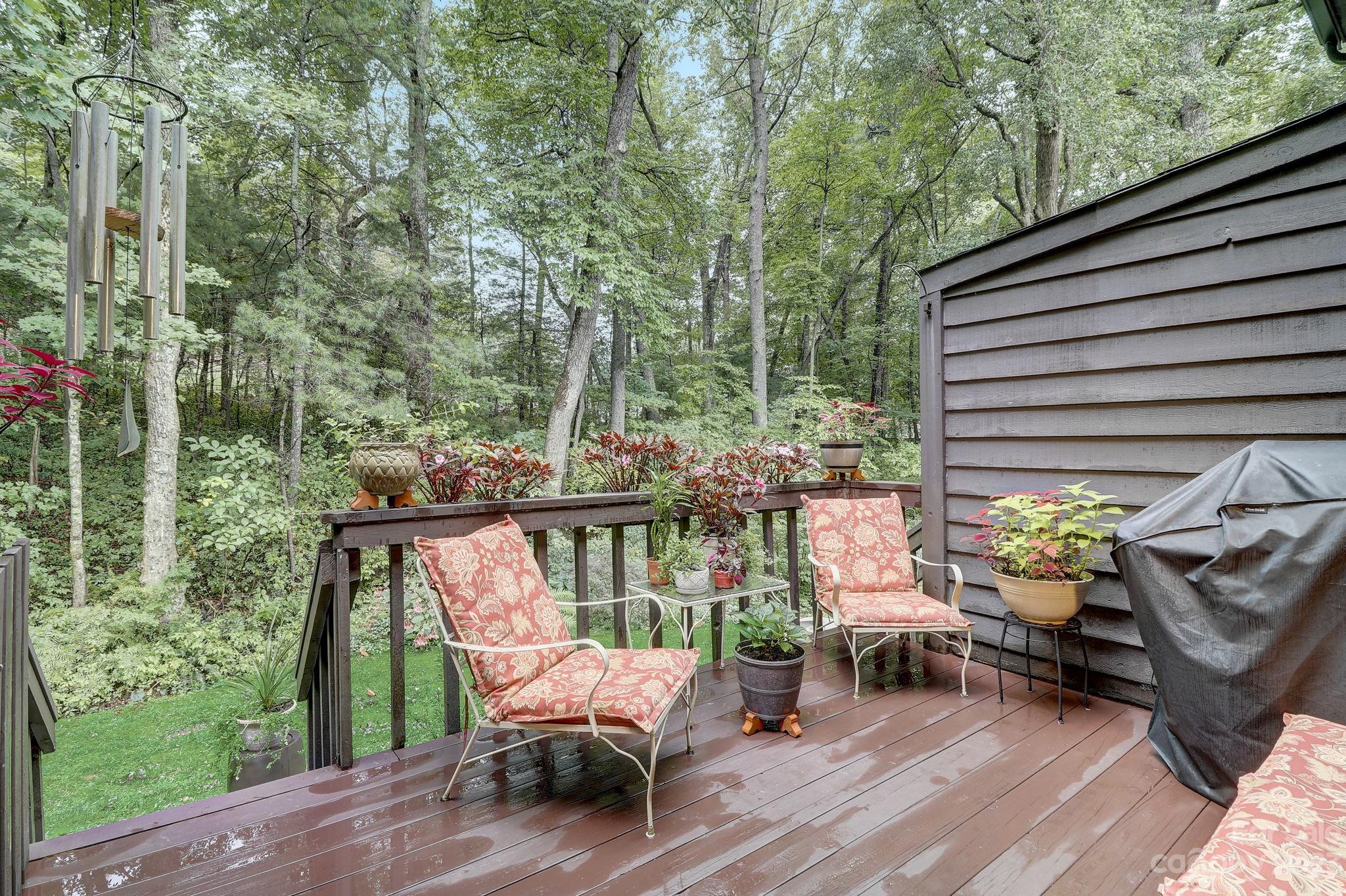 4 Bramblewood Road, Unit 8 Arden, NC 28704 - Photo 20 of 25 a view of a patio with a table chairs and a backyard