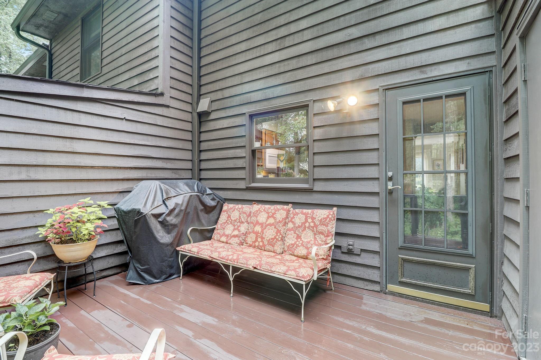 4 Bramblewood Road, Unit 8 Arden, NC 28704 - Photo 21 of 25 a view of a chairs and table in a back yard of the house