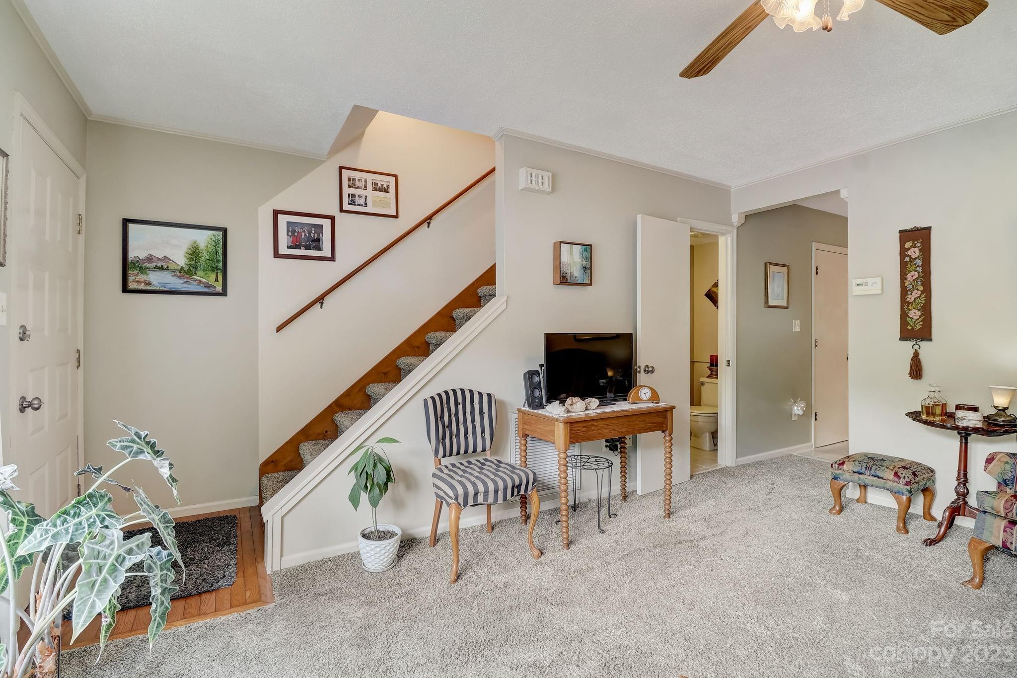 4 Bramblewood Road, Unit 8 Arden, NC 28704 - Photo 5 of 25 a view of a livingroom with furniture and staircase