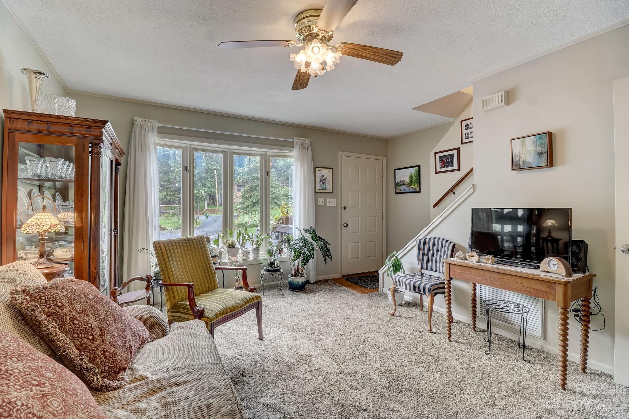 4 Bramblewood Road, Unit 8 Arden, NC 28704 - Photo 6 of 25 a living room with furniture and a flat screen tv