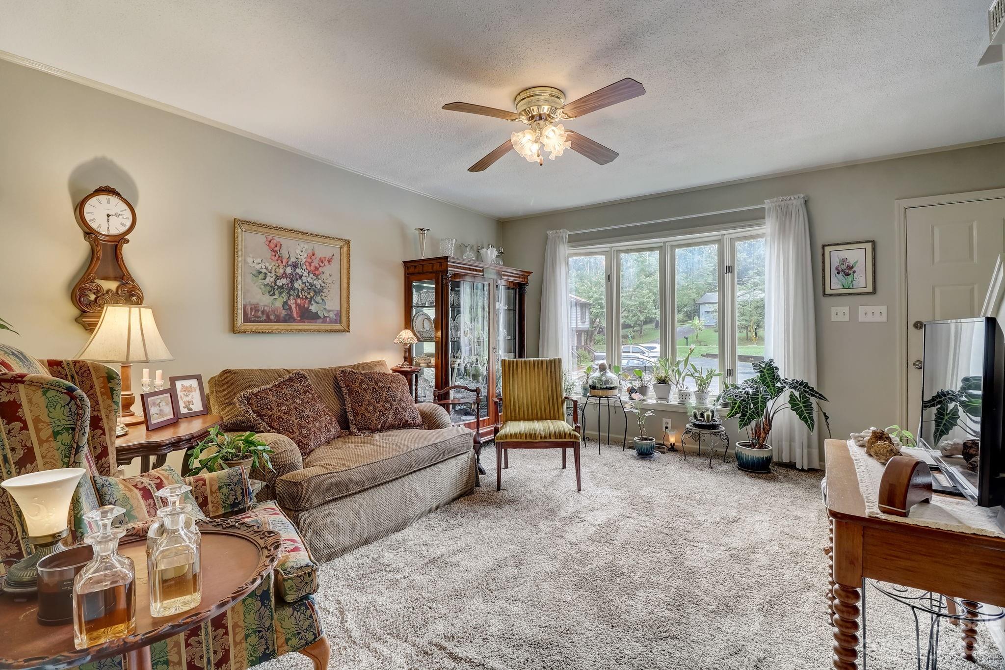 4 Bramblewood Road, Unit 8 Arden, NC 28704 - Photo 7 of 25 a living room with furniture and a large window