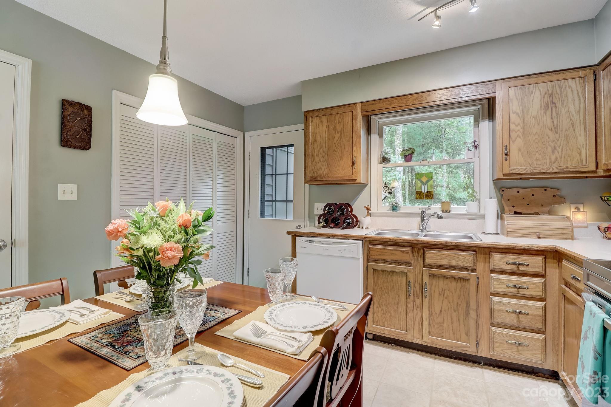 4 Bramblewood Road, Unit 8 Arden, NC 28704 - Photo 10 of 25 a kitchen with a table chairs stove and cabinets