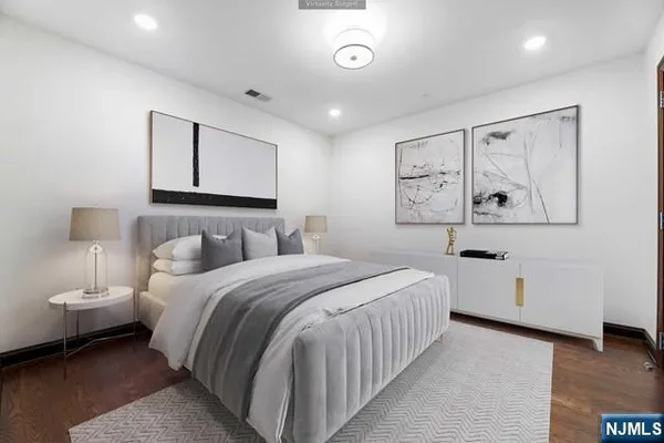 a bedroom with a white bed and white walls