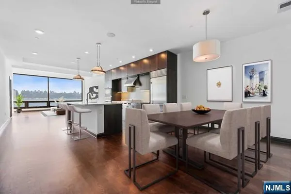 a living room with couches kitchen view and kitchen view